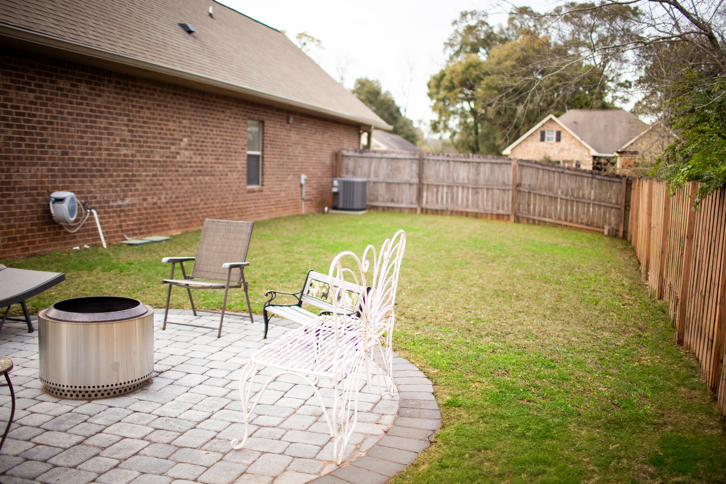 Fenced backyard with fire pit area