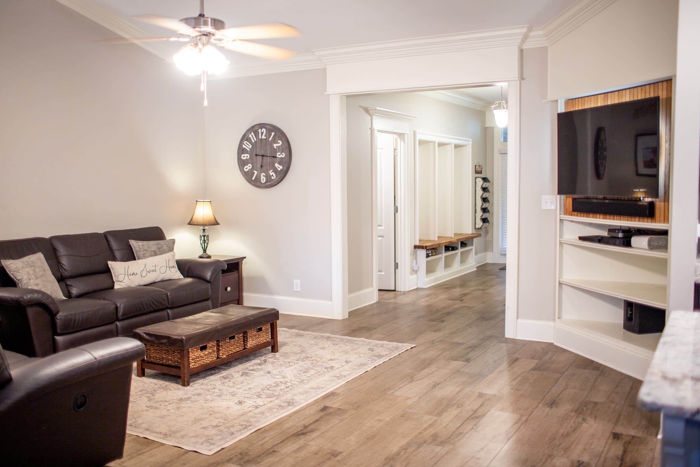 Living room with built-in entertainment center and mudroom entry