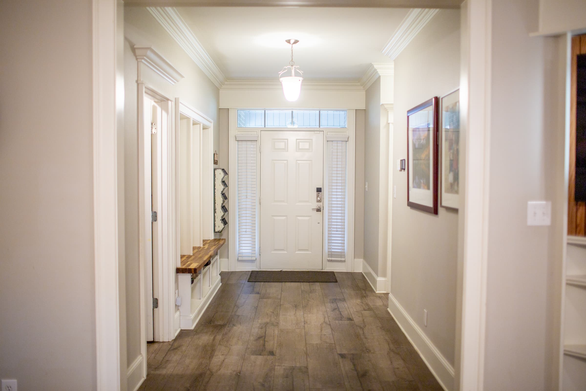 Foyer with front door, sidelights, and built-in bench