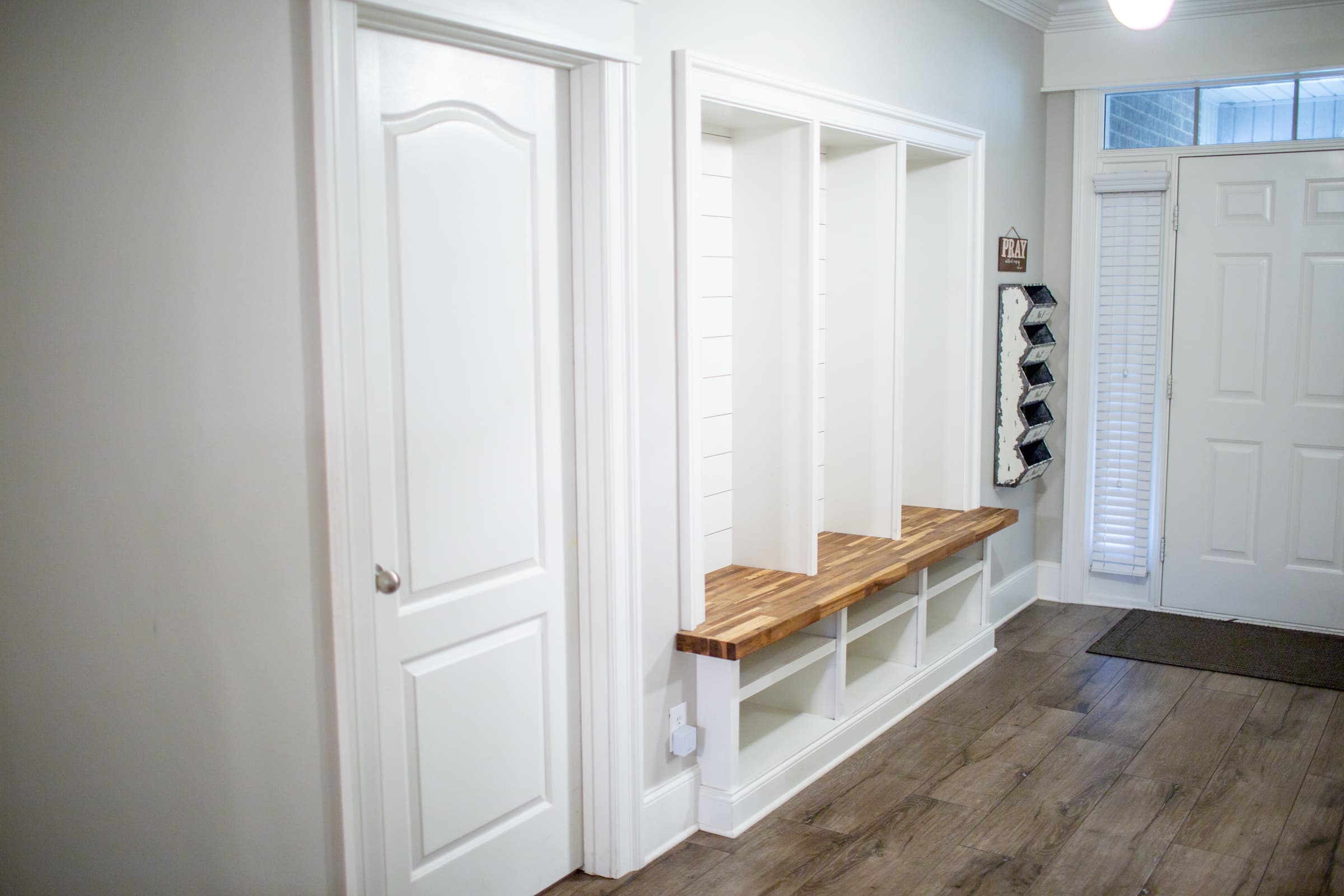 Foyer mudroom with custom built-in cubbies and bench