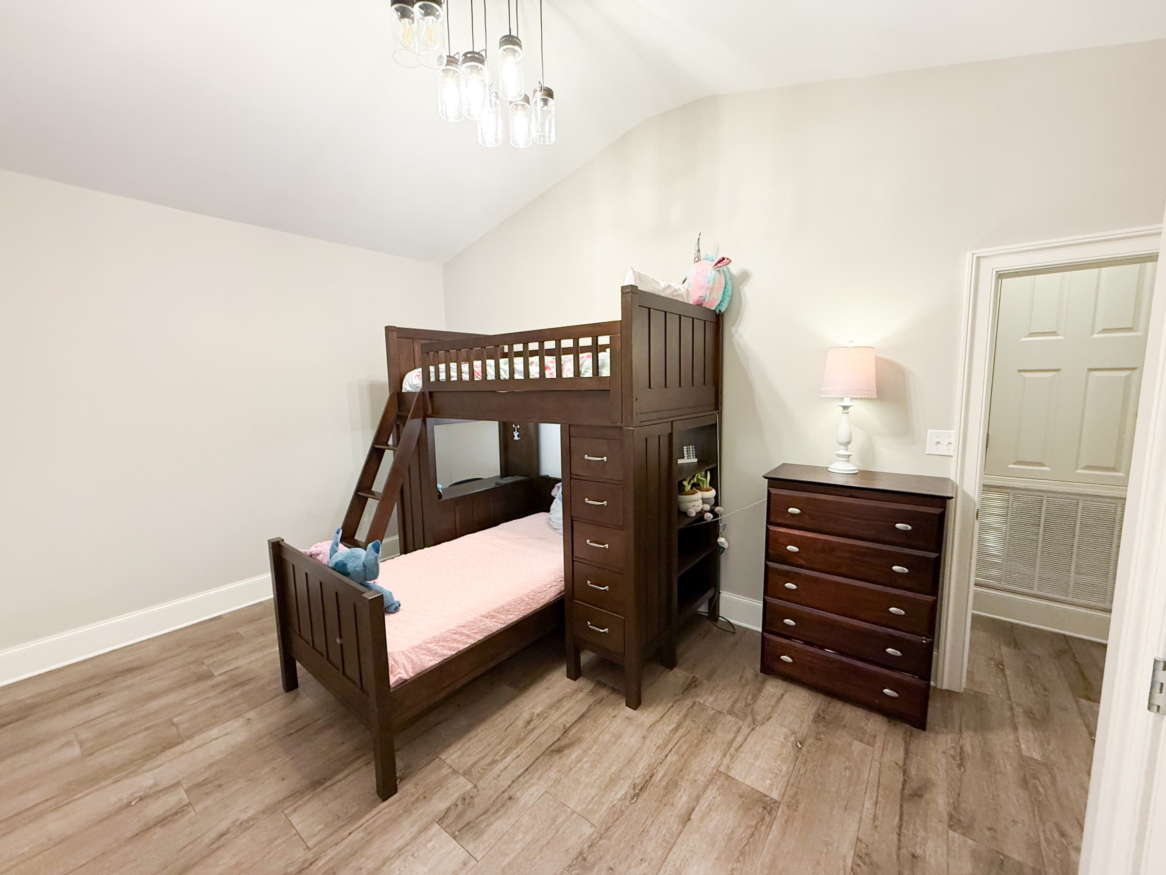 Bedroom with vaulted ceiling, bunk bed, and mason jar chandelier