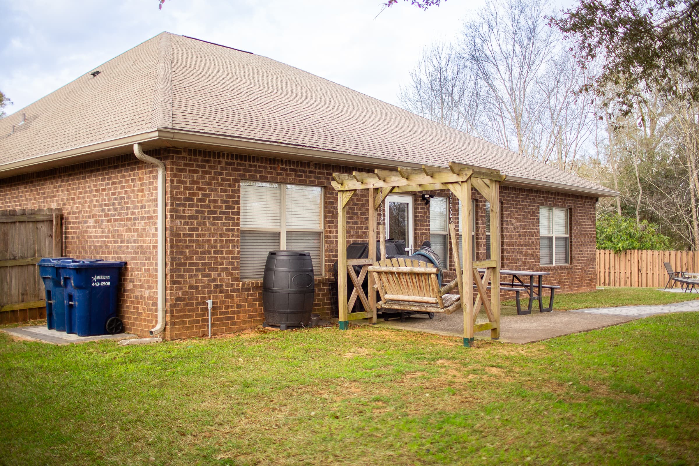Back of home with pergola and patio