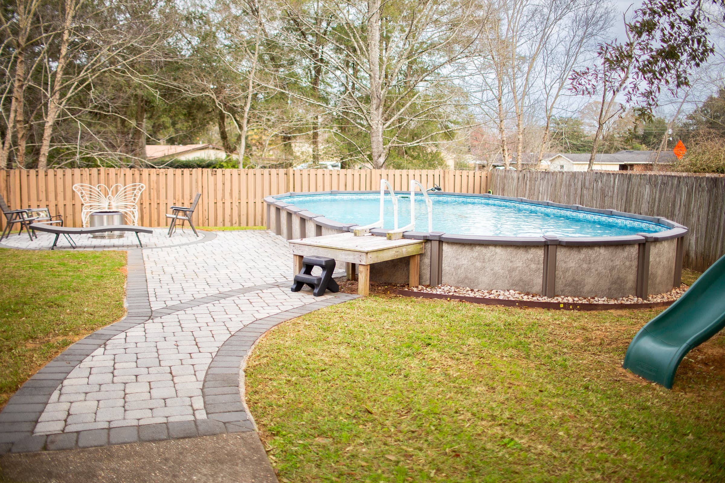 Backyard pool with paver stone walkway